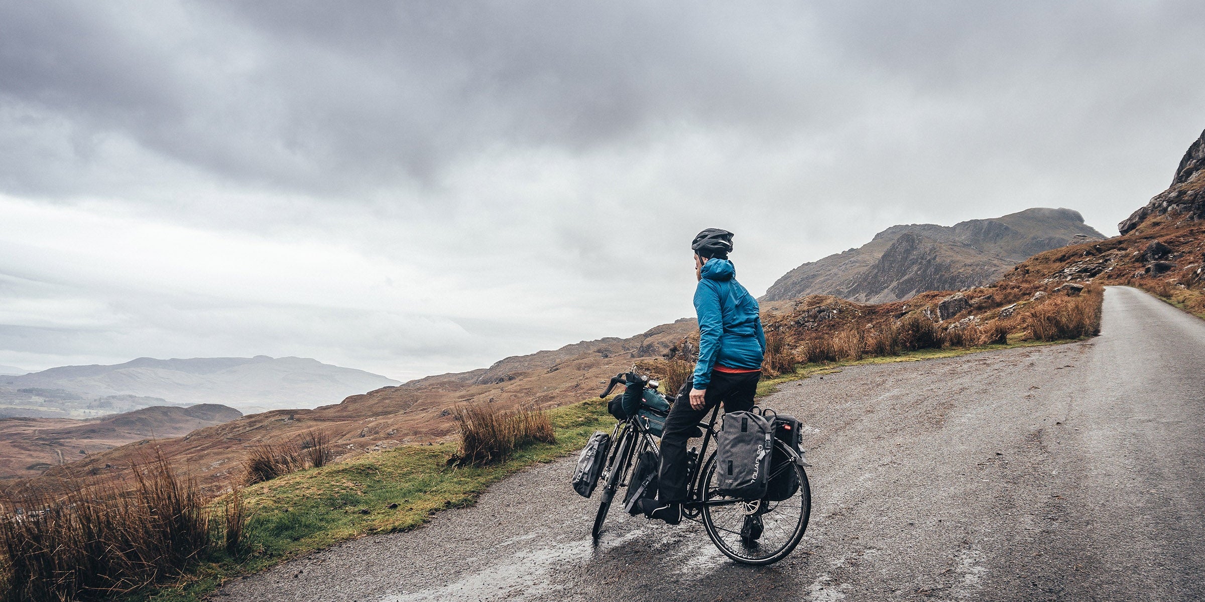 Man on touring bike on a quiet road in North Wales