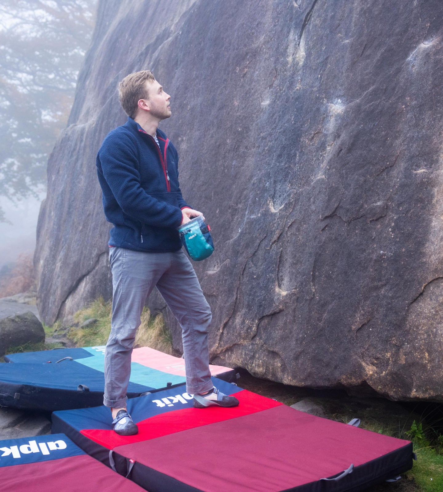 Bouldering above crash pads in the Peak District
