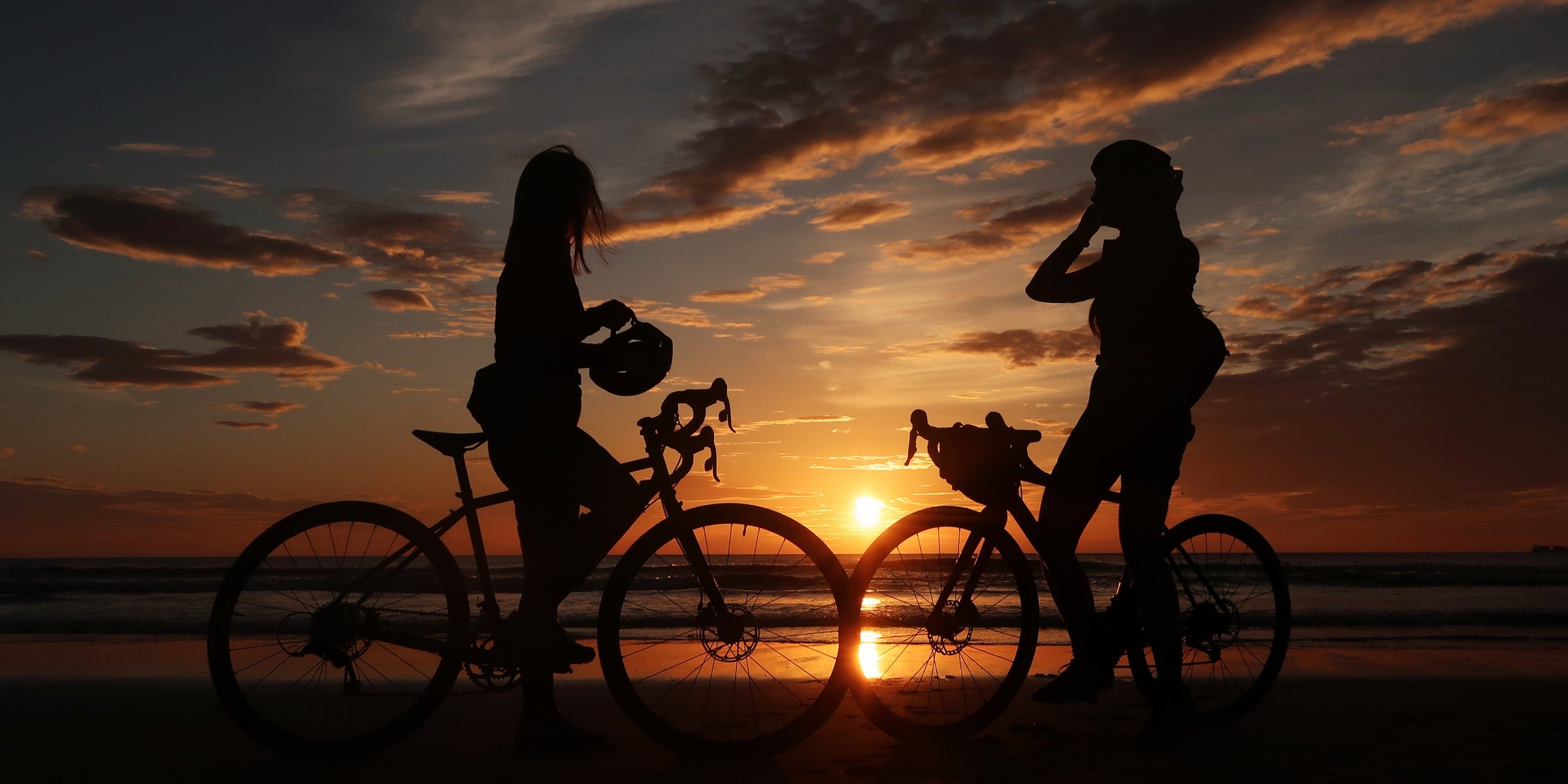Cyclists enjoying the sunset at the end of a C2C route