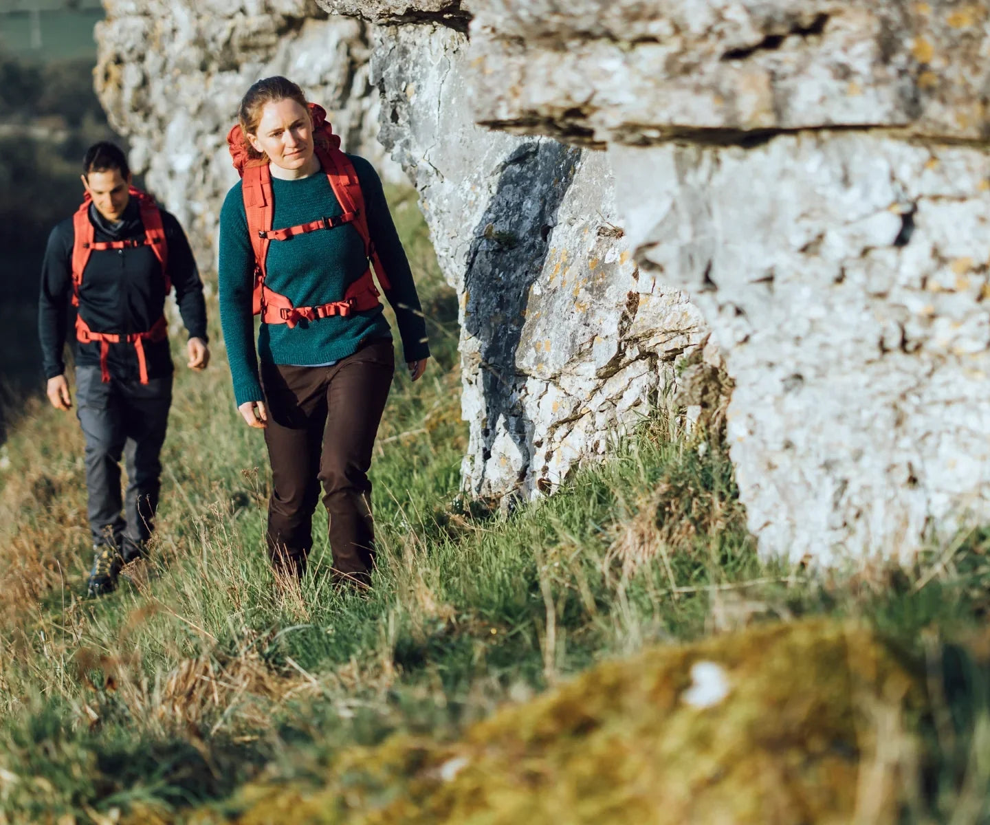 Climbers approaching a rocky outcrop