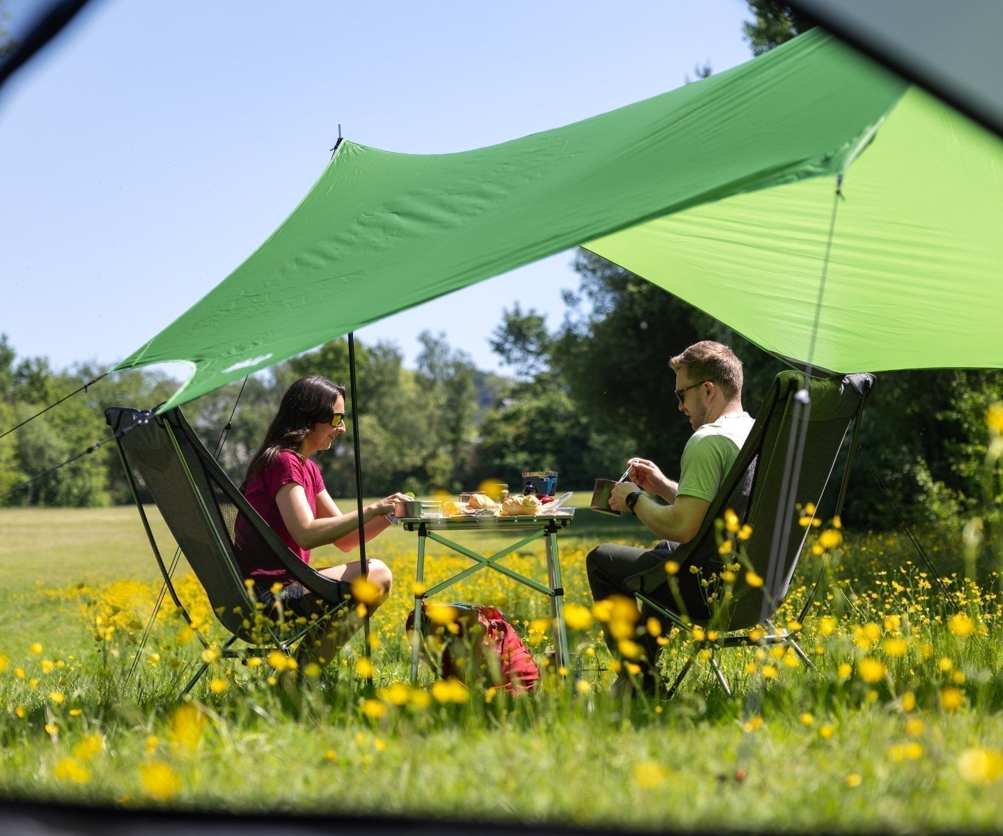 Campers finding shade under a awning