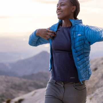 Popping on a down jacket during a break hillwalking