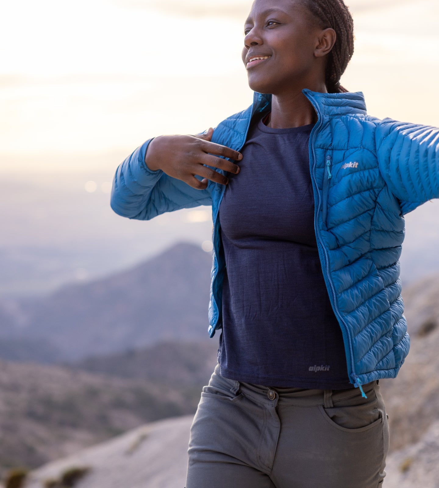 Throwing on a lightweight down jacket on a summit