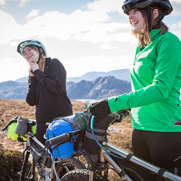 Woman hiking in the mountains in a wool jumper