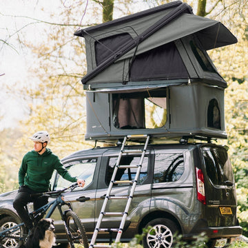 Campers sitting outside a bell tent