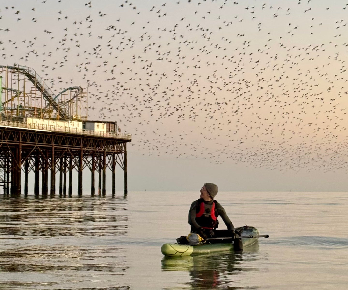 Paddleboarding next to a pier