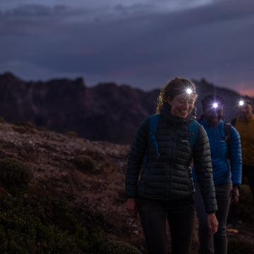 2 campers on an expedition wearing head torches
