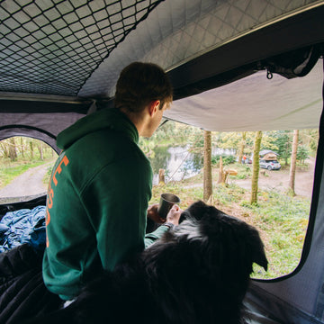 Campers sitting outside a bell tent