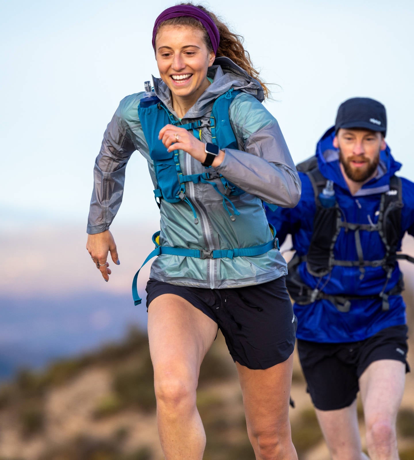 Trail runner using trekking poles in the Alps