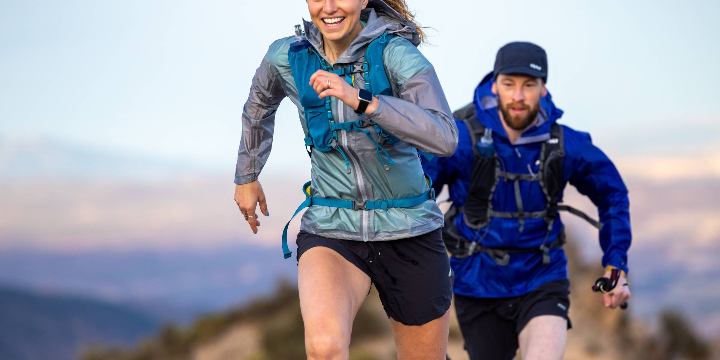 Trail runner using trekking poles in the Alps
