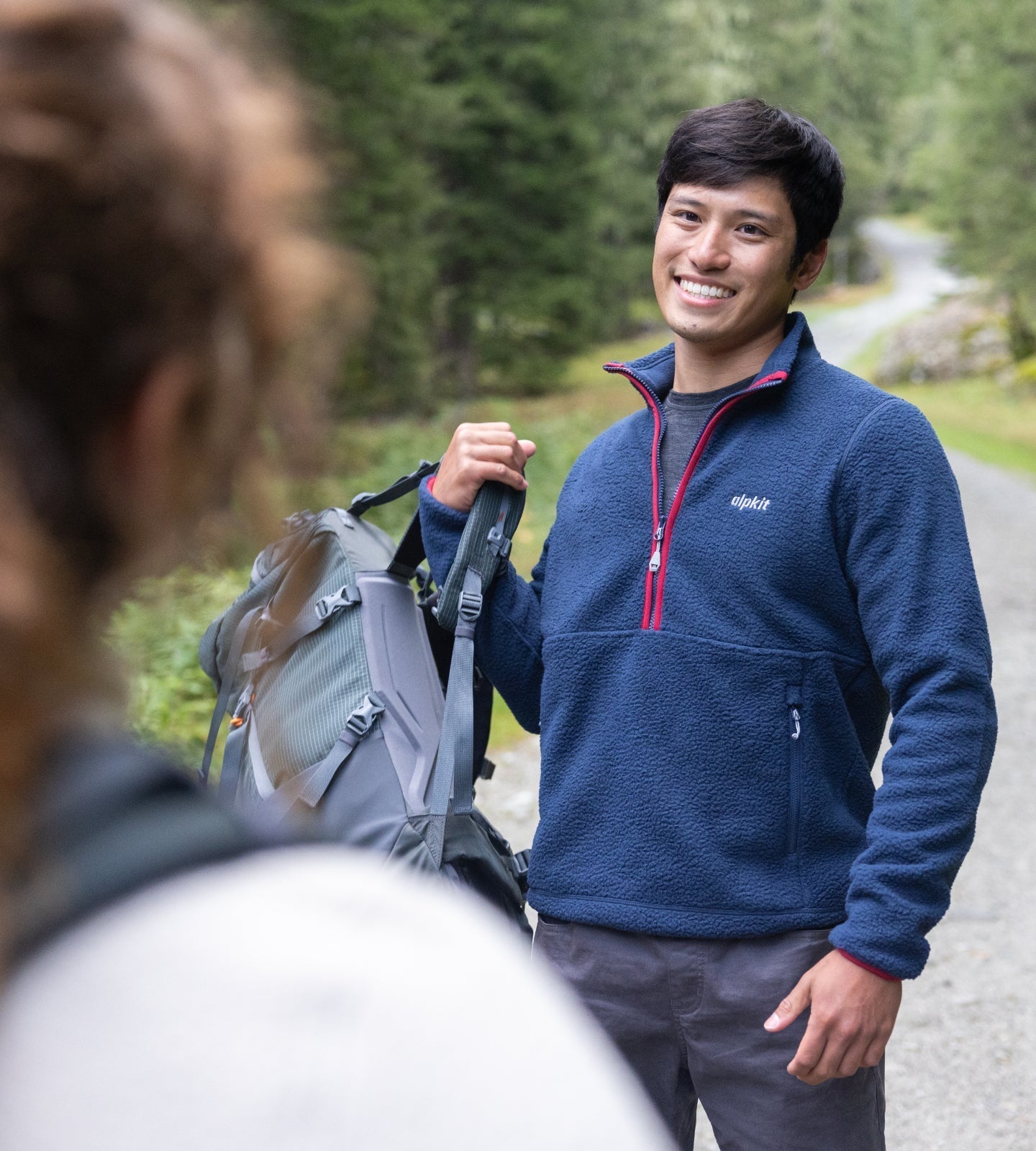 Hiker wearing a fleece pullover on the trail