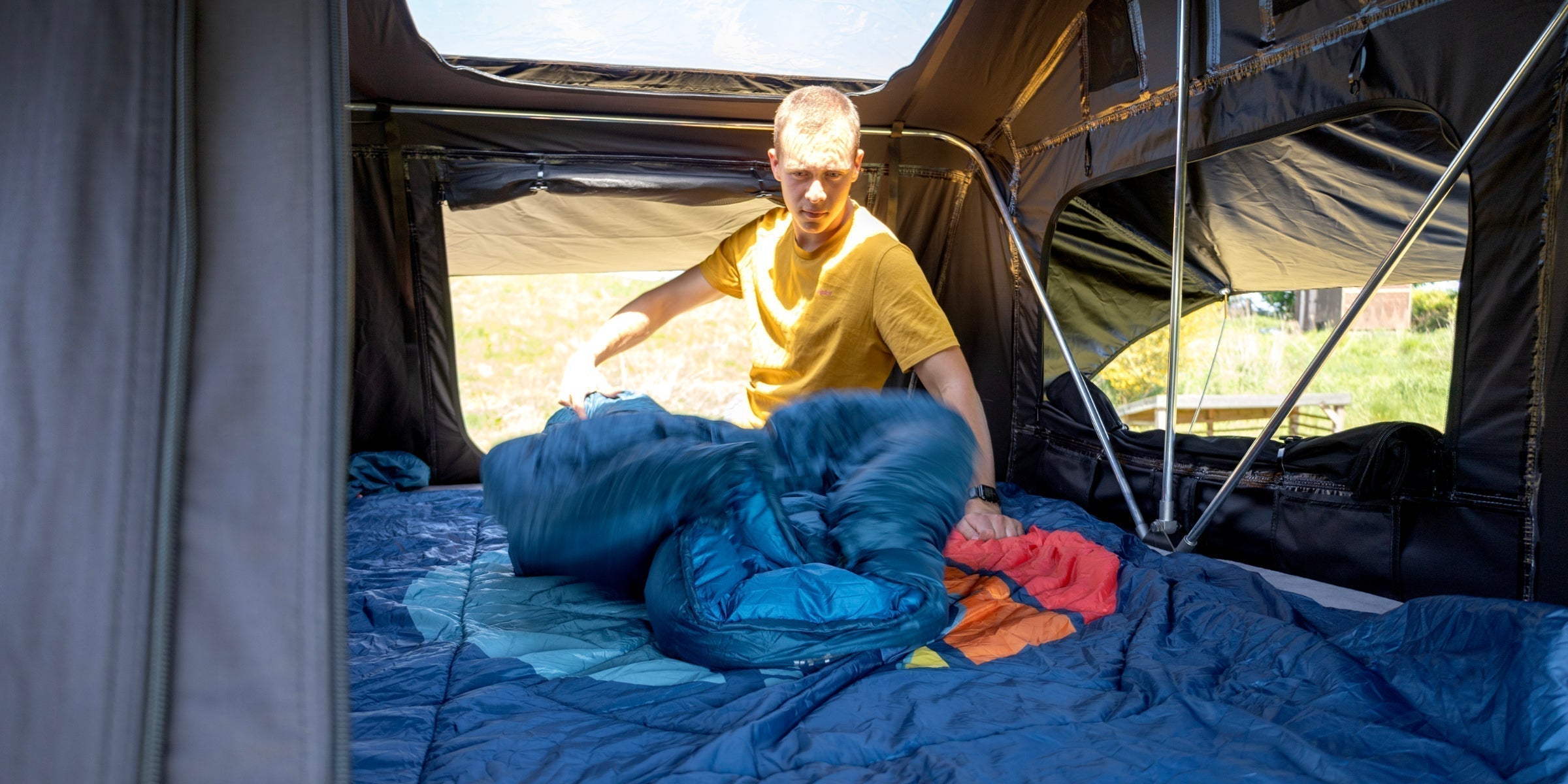 Camper preparing his sleeping bag