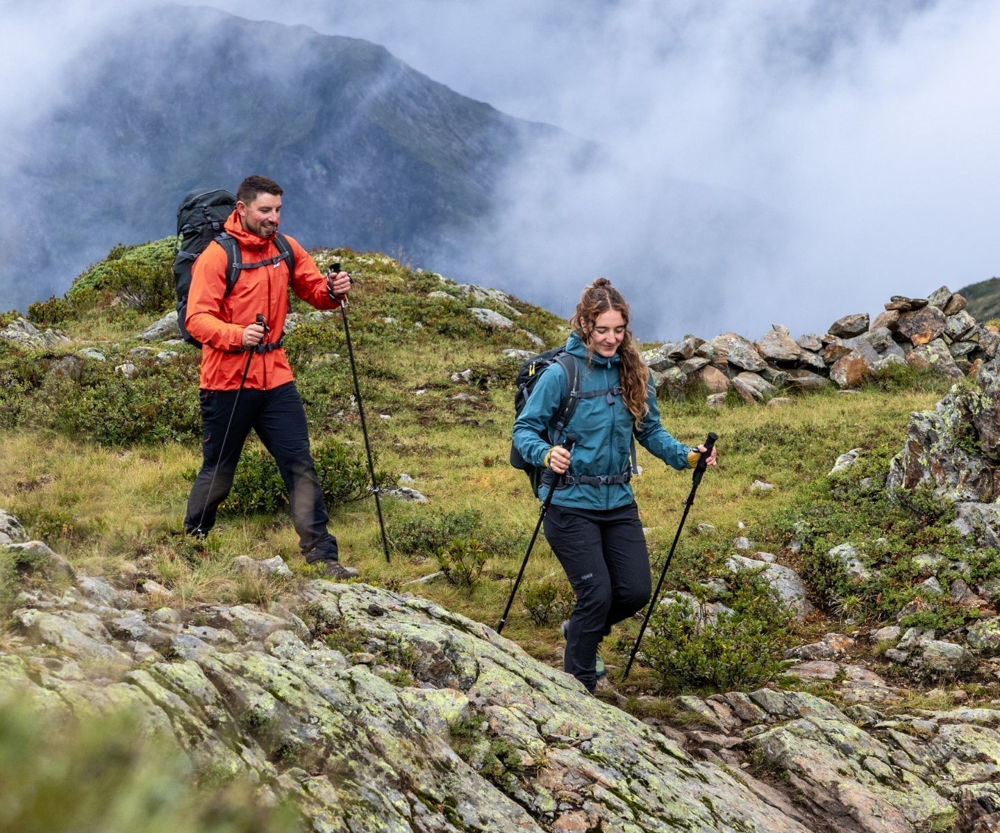 Hikers on a mountain trail dressed in waterproofs