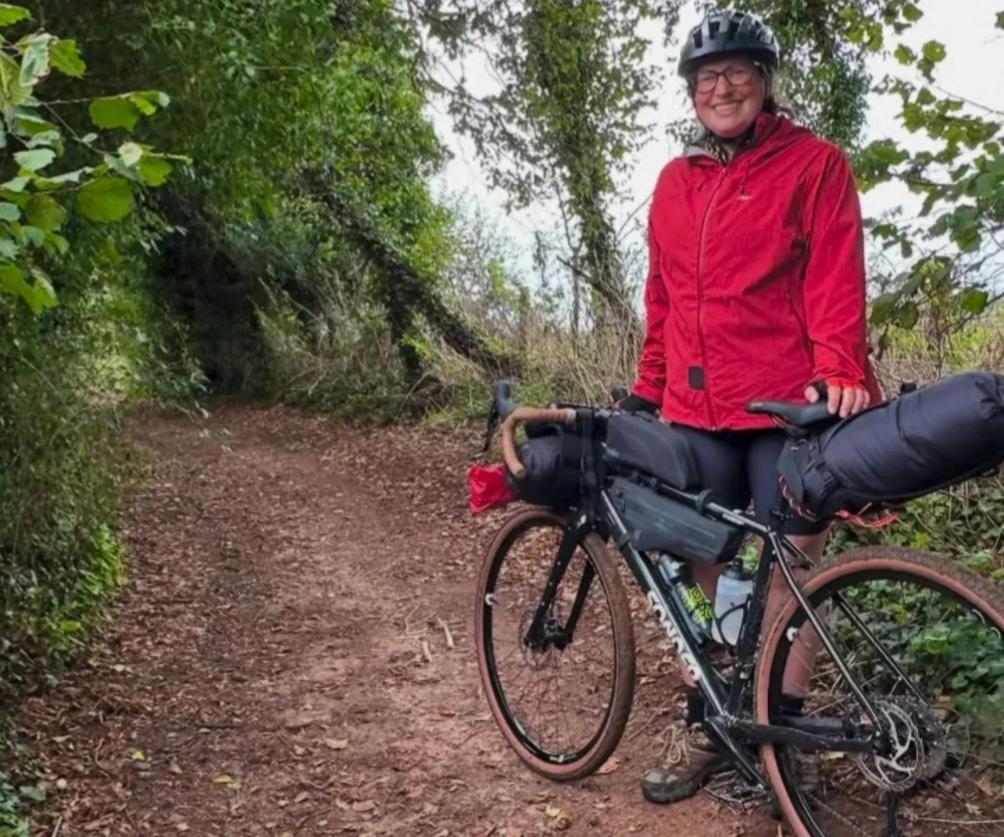 Female rider standing next to a Sonder gravel bike