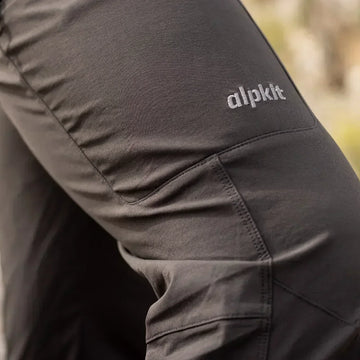 Female climber scrambles up rocks