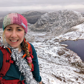 Popping on a down jacket during a break hillwalking