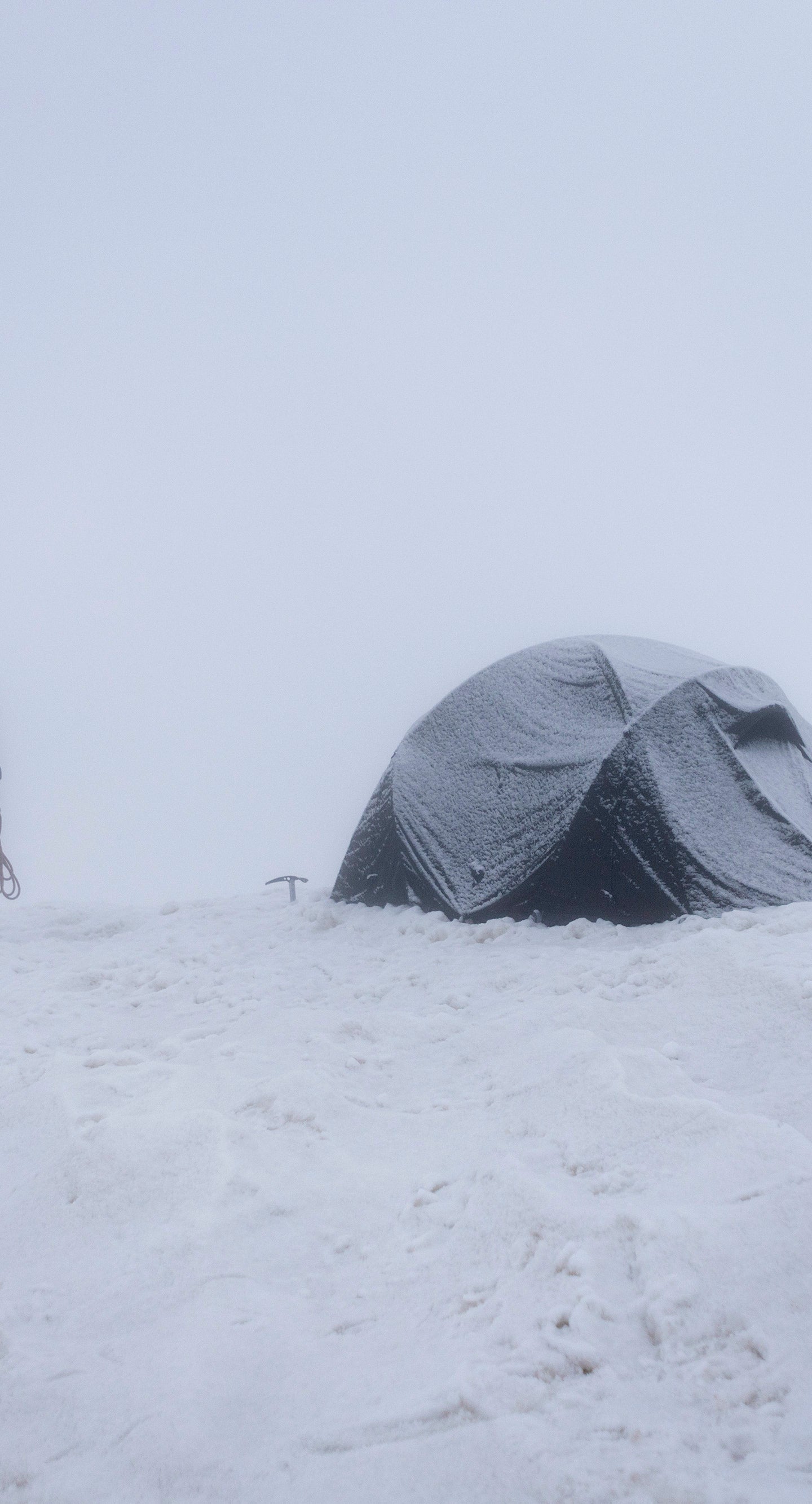 A winter geodesic tent in a whiteout