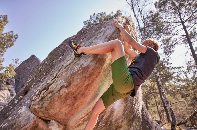 Zofia Reych bouldering in Font wearing green climbing shorts - action