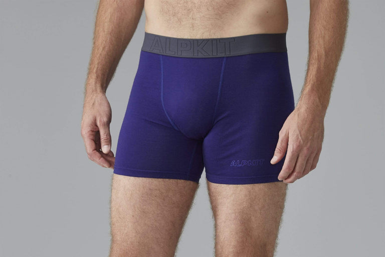 A man modelling blue merino boxer shorts from the front