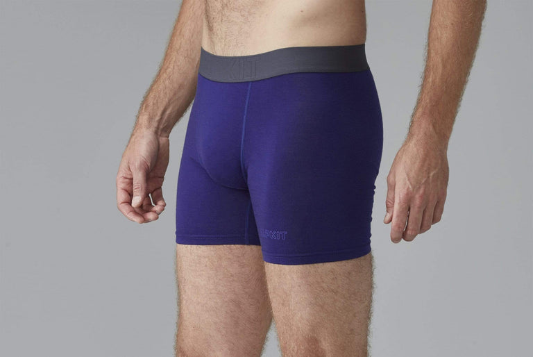 A man modelling blue merino boxer shorts from the side