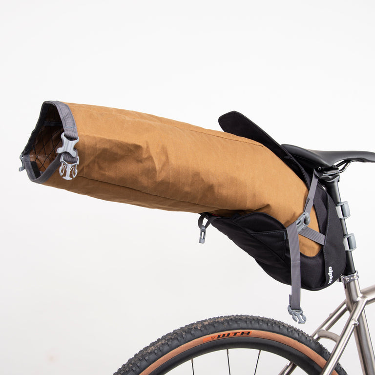 alpkit big papa 17 litre seatpack for bikepacking in mountain brown open