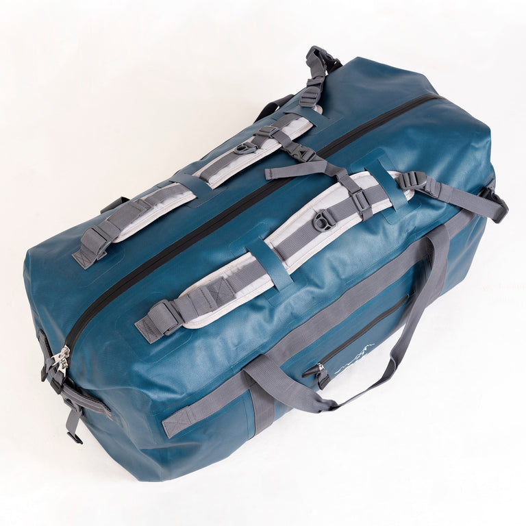 alpkit drydock 100L waterproof duffle bag gear bag in blue backpack straps