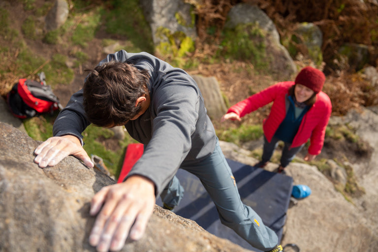 A man bouldering in a stretch fleece top - action - closed