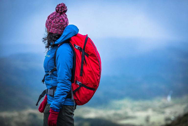 Woman walking with chamois backpack - action